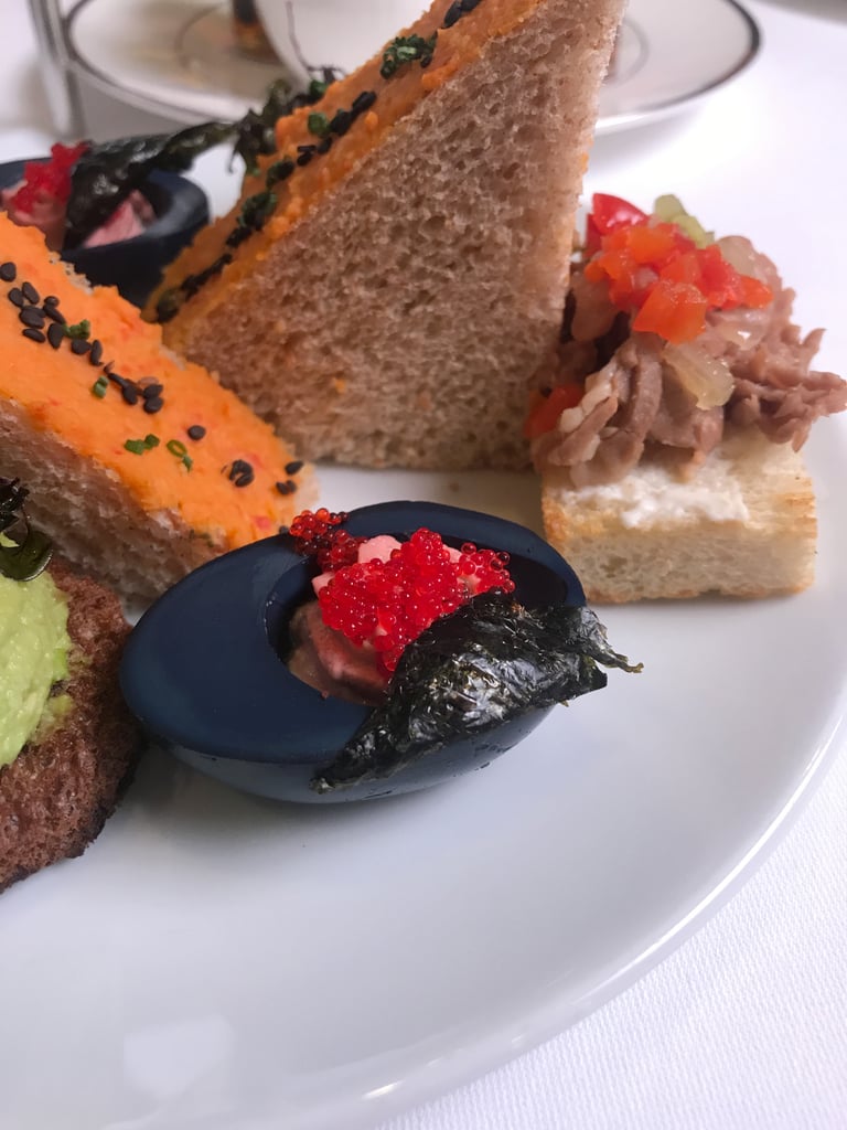 Perhaps the coolest one of all is the Ursula-themed deviled egg. The egg gets its colour from squid ink (!) and blueberry purée, and it's filled with beet purée mixed with the yolk. Topping it off is tobiko caviar and dried seaweed.