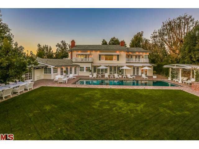 The sprawling backyard is highlighted by this sexy dark-bottomed pool and open-air cabana.