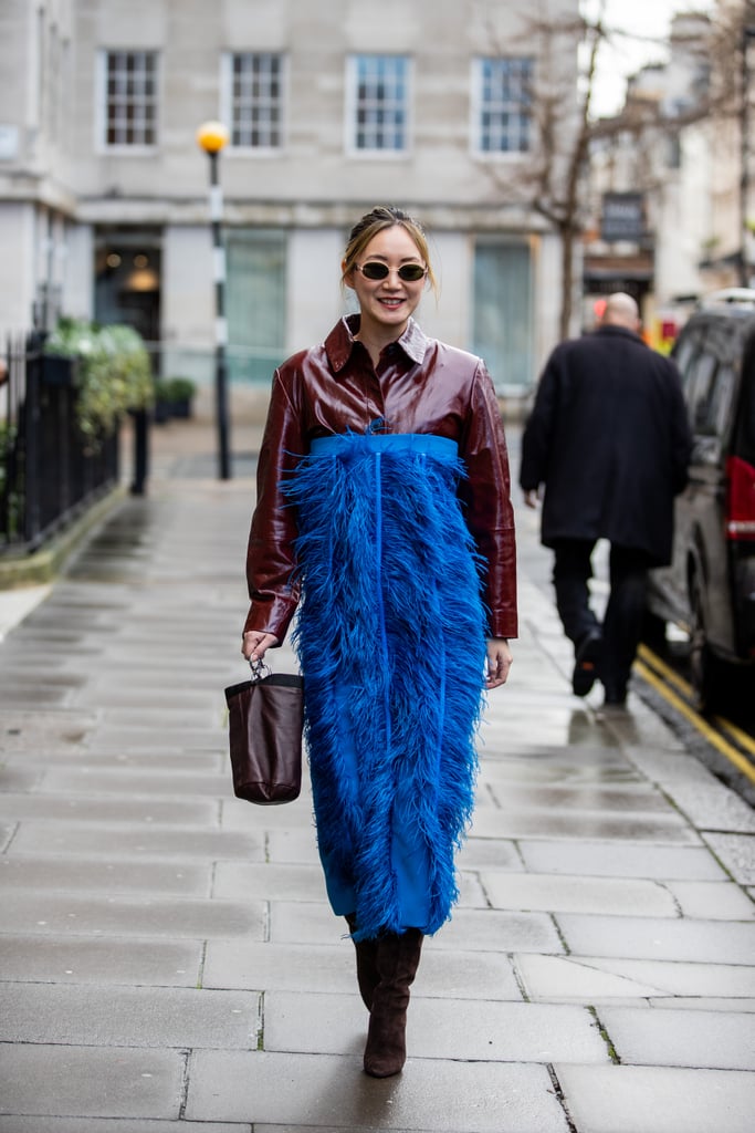 The jewel tone of the lapis skirt complements the rich burgundy colour of the shirt, and the contrasting textures — playful feathers and structured oxford collar — are excellent.