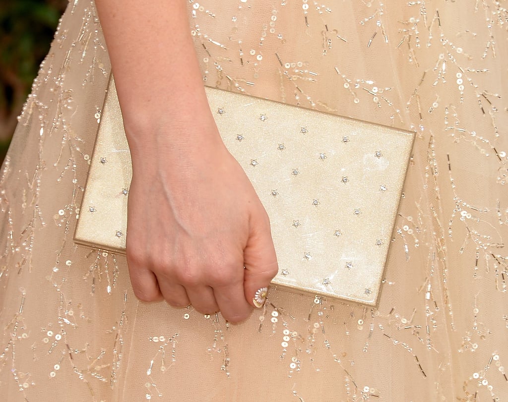 Playing off the pretty palette of her dress, Zooey added a pearl-adorned clutch.
