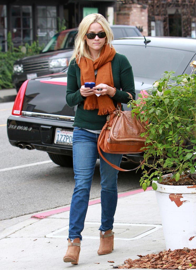 Reese showed off her Fall layering skills with jeans and ankle boots in 2011.