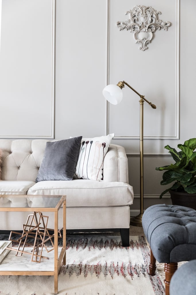 The room was already carpeted, but that didn't stop Monica from adding an amethyst area rug (from $81). An on-trend brass floor lamp and tufted seating, including a pair of dark grey linen lounge chairs ($253 each) make the room feel stylish and inviting.