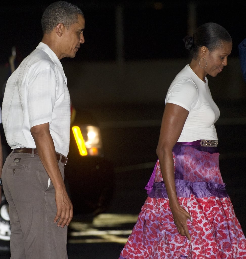 Michelle wearing a leopard-print silk skirt with a white tee leaving Honolulu.