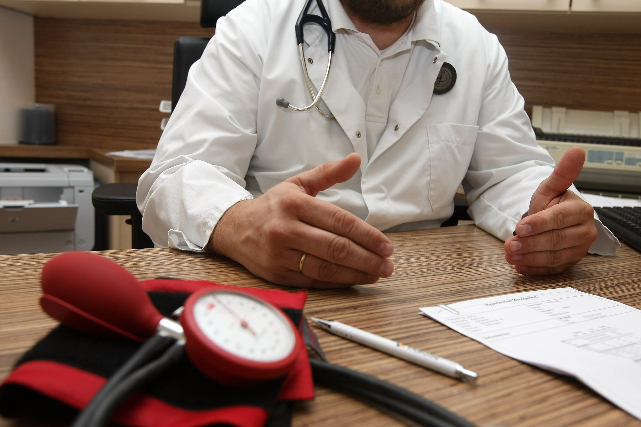 BERLIN, GERMANY - SEPTEMBER 05:  A doctor speaks with a patient about her high blood pressure, or hypertension, on September 5, 2012 in Berlin, Germany. Doctors in the country are demanding higher payments from health insurance companies (Krankenkassen). Over 20 doctors' associations are expected to hold a vote this week over possible strikes and temporary closings of their practices if assurances that a requested additional annual increase of 3.5 billion euros (4,390,475,550 USD) in payments are not provided. The Kassenaerztlichen Bundesvereinigung (KBV), the National Association of Statutory Health Insurance Physicians, unexpectedly broke off talks with the health insurance companies on Monday.  (Photo by Adam Berry/Getty Images)