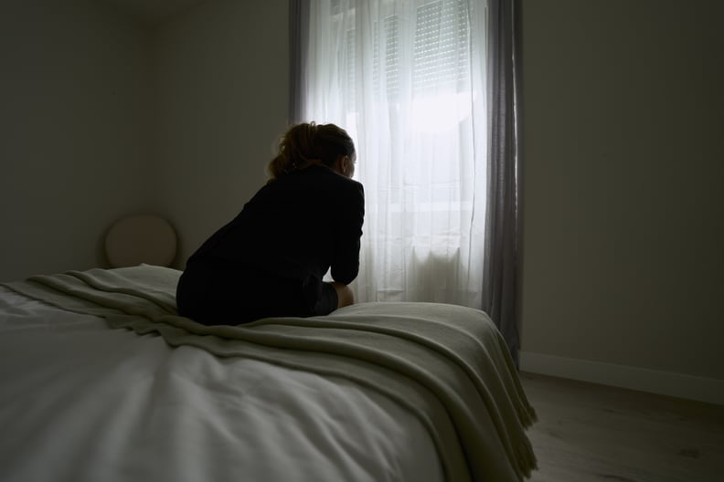 woman sitting on the edge of a bed