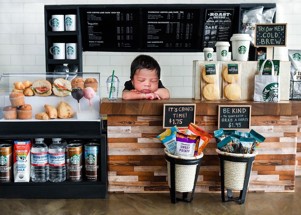 For Erika Seress, a photographer at The Pod Photography in Culver City, CA, getting every last detail right when staging a photo shoot is the name of the game. Recently, she worked with a family to create a lifelike Starbucks backdrop for a newborn session — apparently the little guy's dad is obsessed with Starbucks! — and it's actually a mini version of a full-on store.
"I personally made every detail of the set myself," Erika told POPSUGAR. "I made the counter out of crates covered with scrapbooking paper and a walnut shelf piece. The bakery case is a Hallmark Cupcake Keepsake ornament case. I wrapped twine around plastic flower pots and then painted Popsicle sticks black for the legs. The mini chip bags are actual Starbucks chip bags that I cut into fours and then stuffed with cotton balls before gluing closed, and the mini Starbucks cups are a mix of Christmas tree ornaments. We also glued logos onto the white mugs in the background!"
As for the food? Erika either bought it or made it herself, so yes, we're definitely impressed! Scroll ahead to get a look at this incredibly sweet newborn photo shoot that will make you want to order a venti frap ASAP.

    Related:

            
            
                                    
                            

            Phoenix, Oscar, Leo, Arlo, and 170 More of the Cutest Names For Baby Boys
