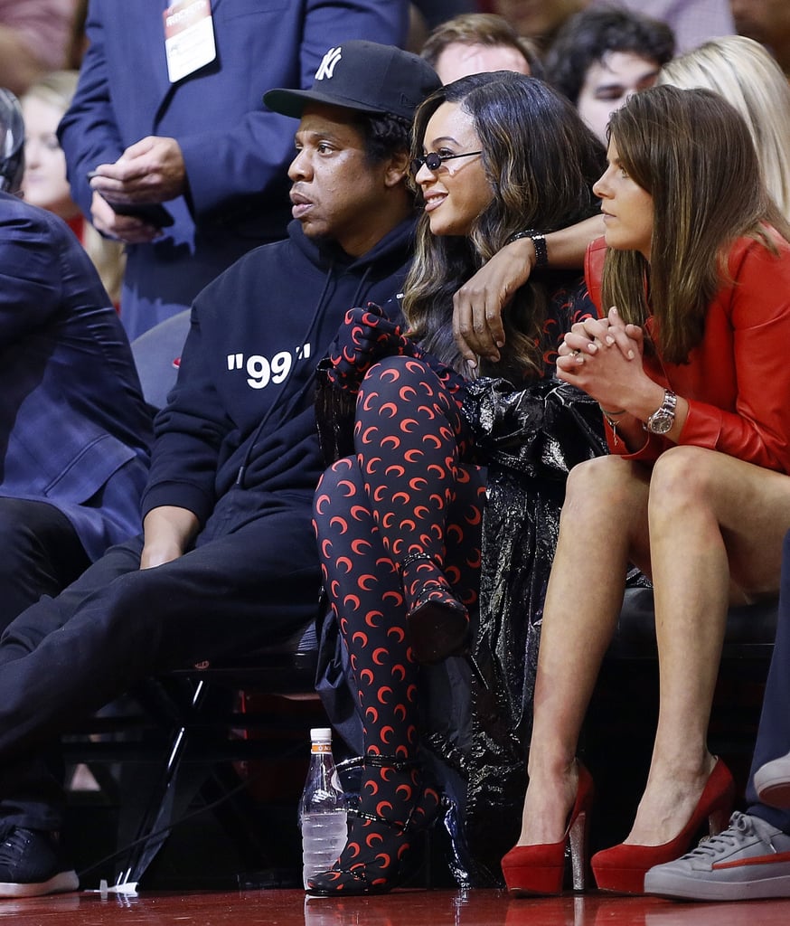 Beyoncé wore Marine Serre's iconic moon print to the NBA playoffs in Houston, TX, in 2019, and JAY sat by her side in a graphic hoodie and Yankees hat.