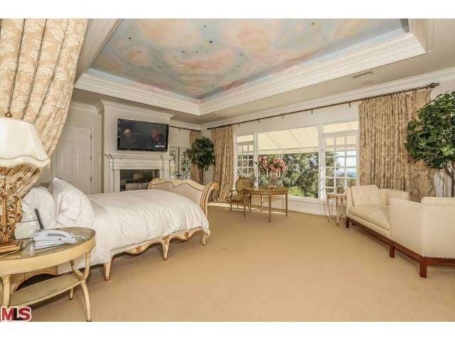 This well-appointed bedroom is one of seven in the home.