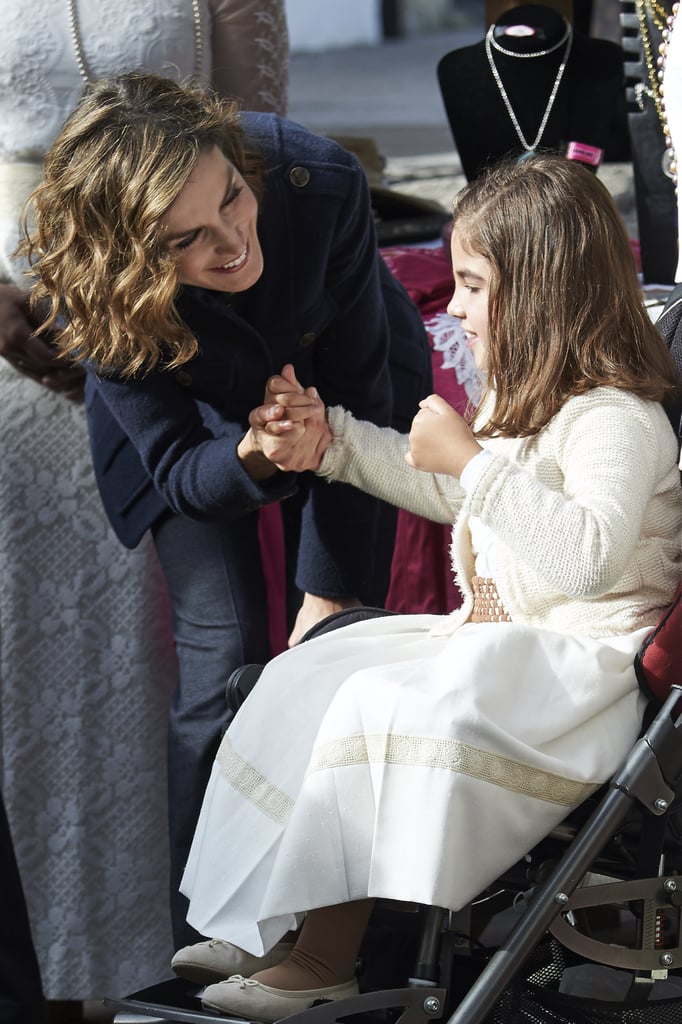Queen Letizia greeted a young girl during an October visit to the village of Colombres.