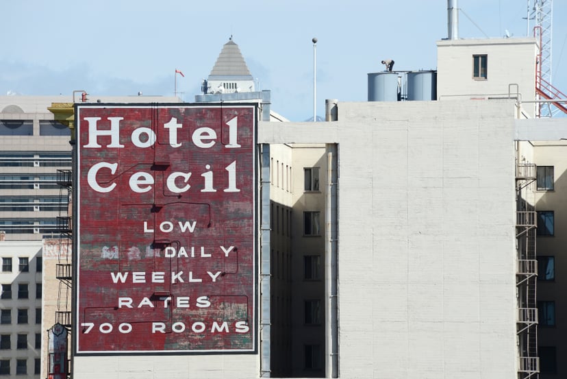 A worker stands on a water tank on the roof of the Hotel Cecil in Los Angeles California February 20, 2013. The body of 21-year-old Canadian tourist Elisa Lam was found in a water tank on the roof of the hotel three weeks after she went missing, police sa