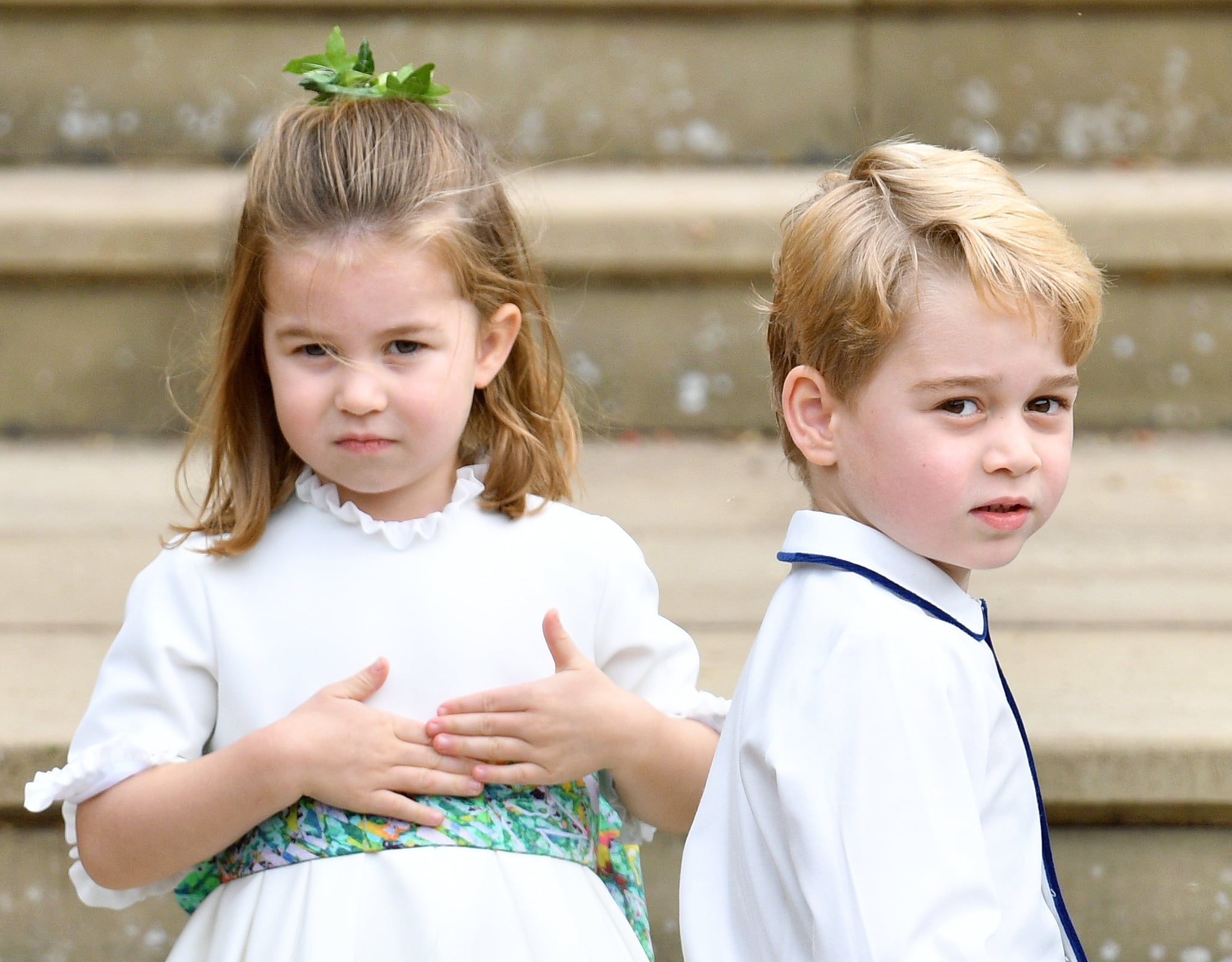 WINDSOR, UNITED KINGDOM - OCTOBER 12: (EMBARGOED FOR PUBLICATION IN UK NEWSPAPERS UNTIL 24 HOURS AFTER CREATE DATE AND TIME) Princess Charlotte of Cambridge and Prince George of Cambridge attend the wedding of Princess Eugenie of York and Jack Brooksbank at St George's Chapel on October 12, 2018 in Windsor, England. (Photo by Pool/Max Mumby/Getty Images)