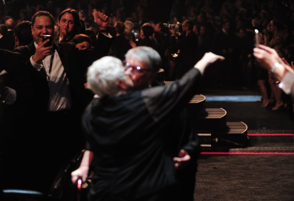 People leaned in to take pictures as couples kissed.