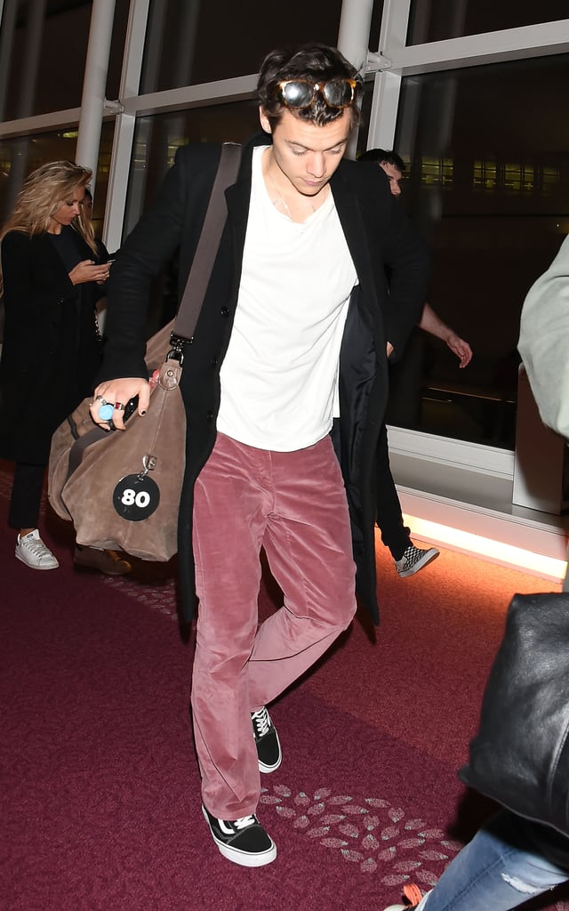 At the airport in 2017 styling pink suede pants with a pair of black Vans.