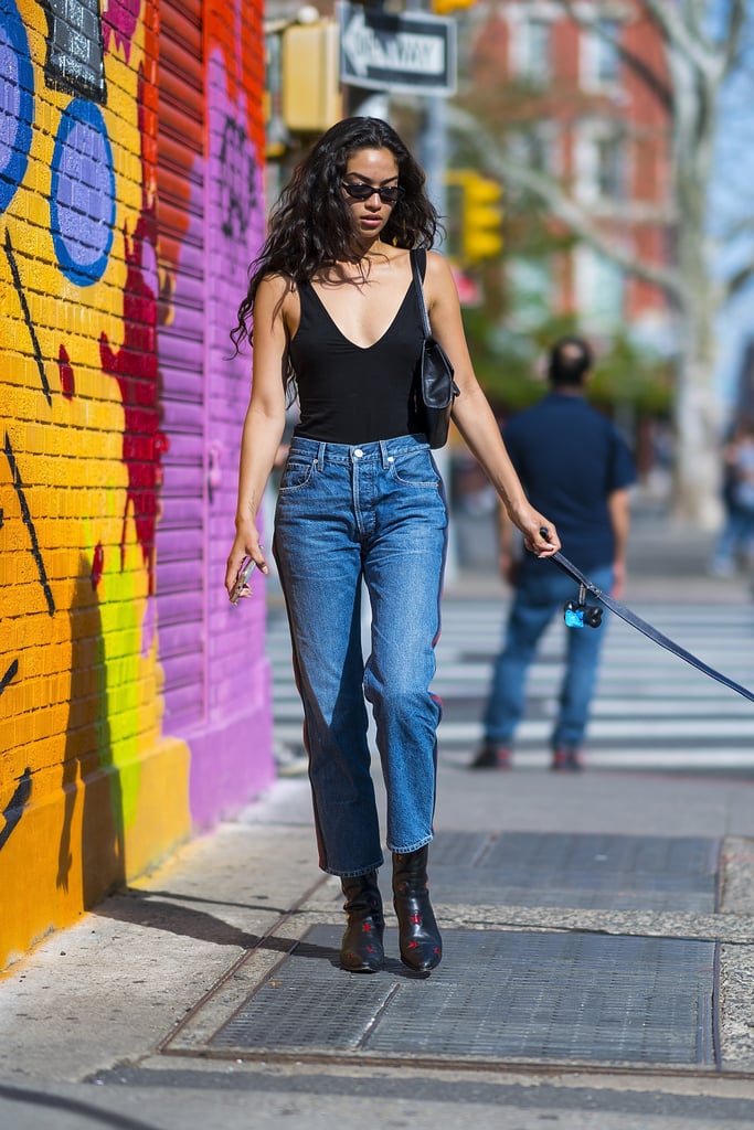 For a sexy casual look, team yours with a plunge-neck strappy black top and black boots.