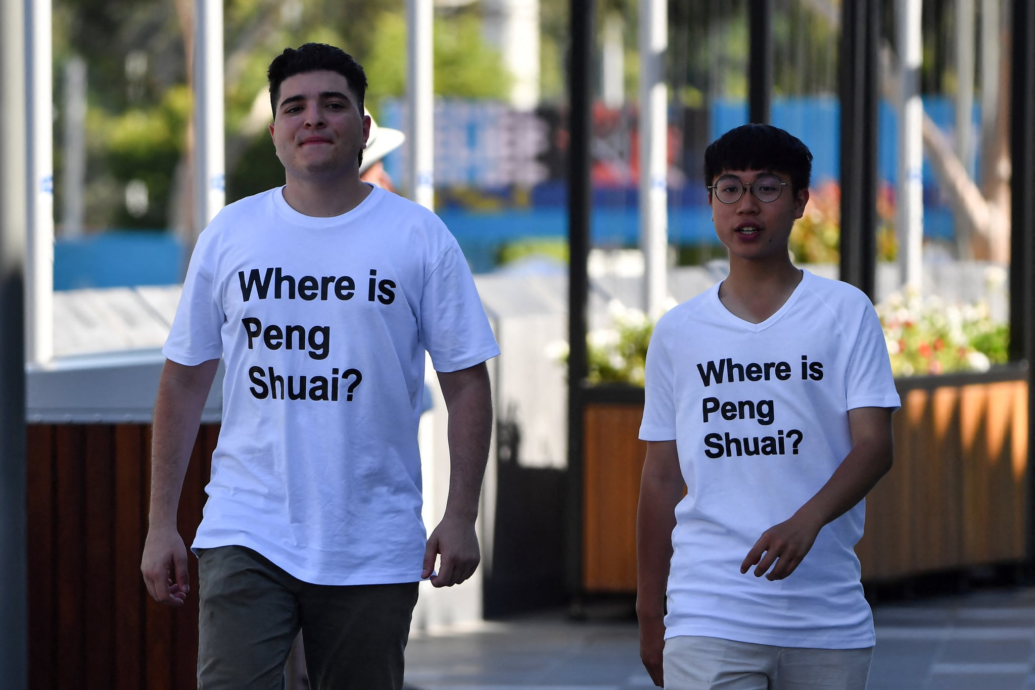 Drew Pavlou (L) is pictured wearing a "Where is Peng Shuai?" t-shirt