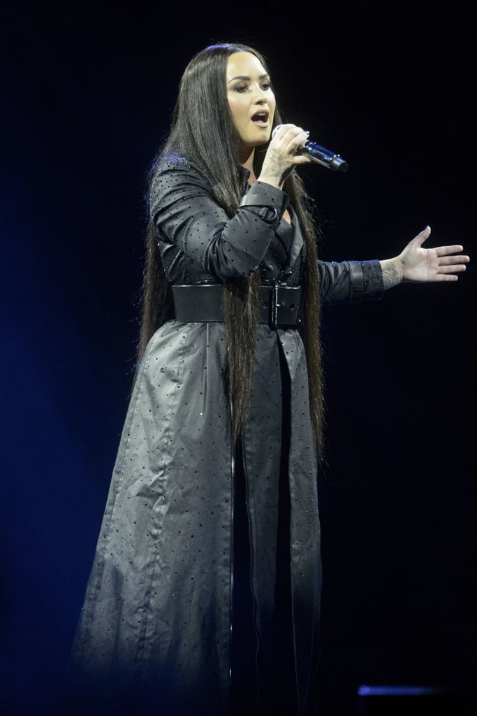 After cancelling appearances earlier in the week, Lovato projected poise in a floor-length trench dress adorned with black rhinestones at the SSE Hydro in Glasgow, Scotland, in 2018.
