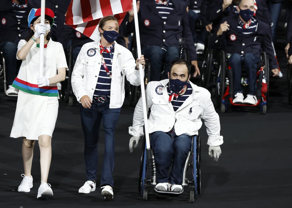 Team USA flag bearers Melissa Stockwell and Charles Aoki entering the 2021 Paralympics opening ceremony during the Parade of Nations.