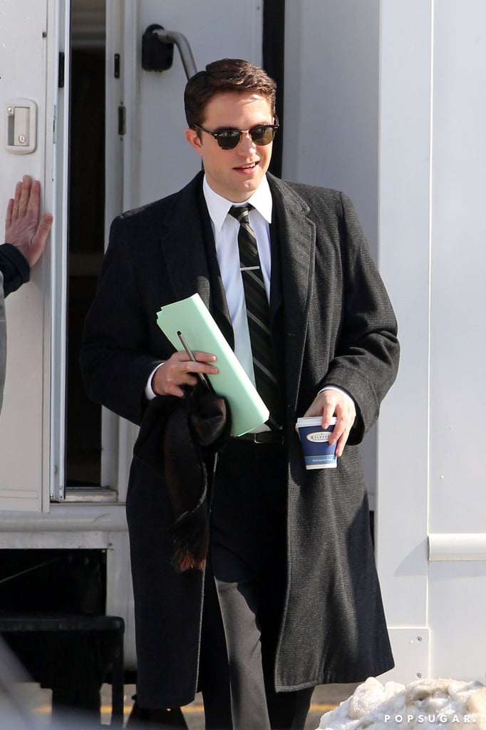 After debuting his new black hair, Robert Pattinson got back to work on the set of his latest film, Life, in Toronto on Wednesday. The actor was dressed very differently from the first time we saw him on set, trading the dapper vintage suit for his usual uniform of jeans, a sweatshirt, and a jacket. However, he later got back into hist suit to film a street scene. In Life, Robert plays the magazine's famed photographer Dennis Stock, as he attempts to photograph James Dean (who will be played by Dane DeHaan). While Robert is perhaps best known for his role of Edward Cullen in the Twilight series, he has a slew of post-vampire-life films coming out this year and in 2015, starting with The Rover this Summer. Rob will also appear in Maps to Our Stars alongside Mia Wasikowska, Julianne Moore, and John Cusack. He has a busy time ahead of him as he is slated to start work on The Lost City of Z and The Childhood of a Leader later this year.