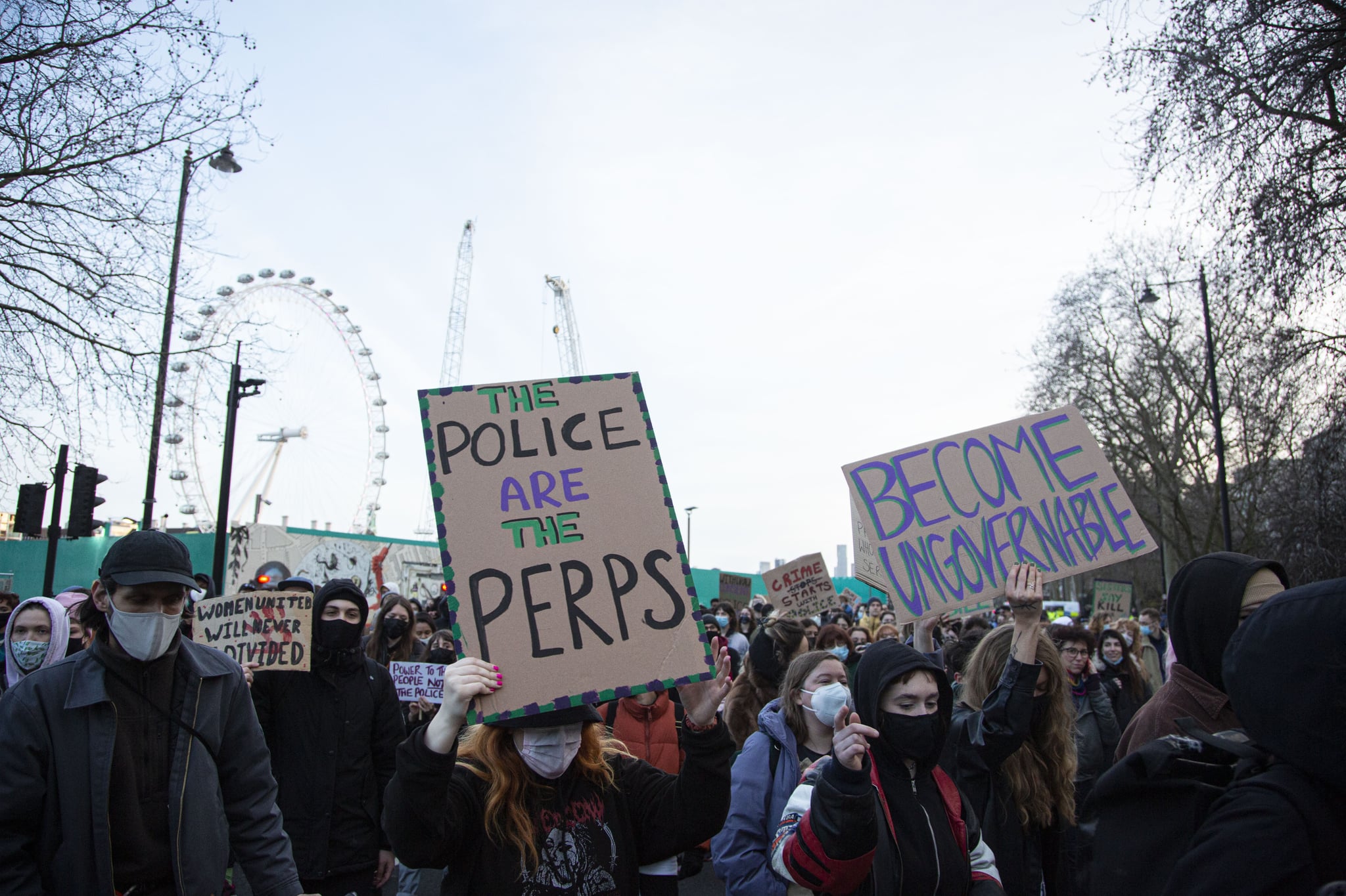 LlONDON, ENGLAND - MARCH 12: Activists attend a protest, called by Sisters Uncut, outside Scotland Yard, where they blocked the road before marching towards the West End on March 12, 2022 in London, United Kingdom. The protest was held to mark a year since the Clapham Common vigil for Sarah Everard, who was murdered by a serving Met police officer Wayne Couzens, and the controversy over the actions by the Met Police during the vigil. (Photo by Rasid Necati Aslim/Anadolu Agency via Getty Images)