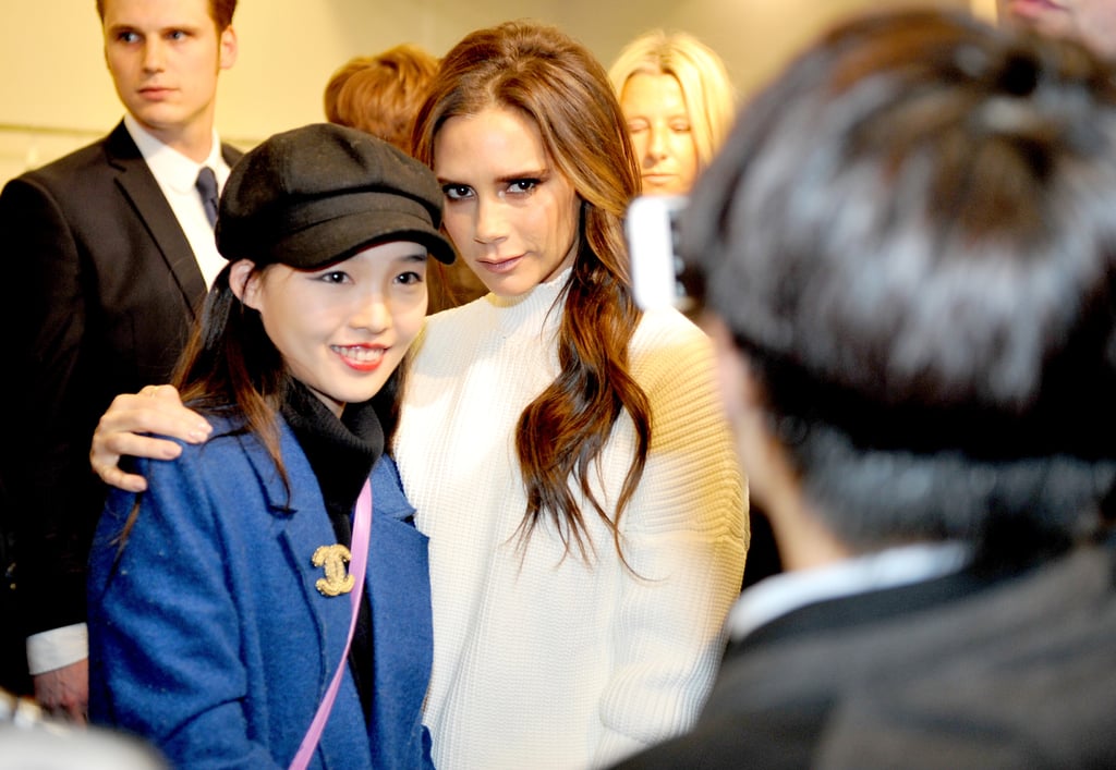 Victoria Beckham struck a pose with a fan at her boutique in Manchester, England, on Wednesday.