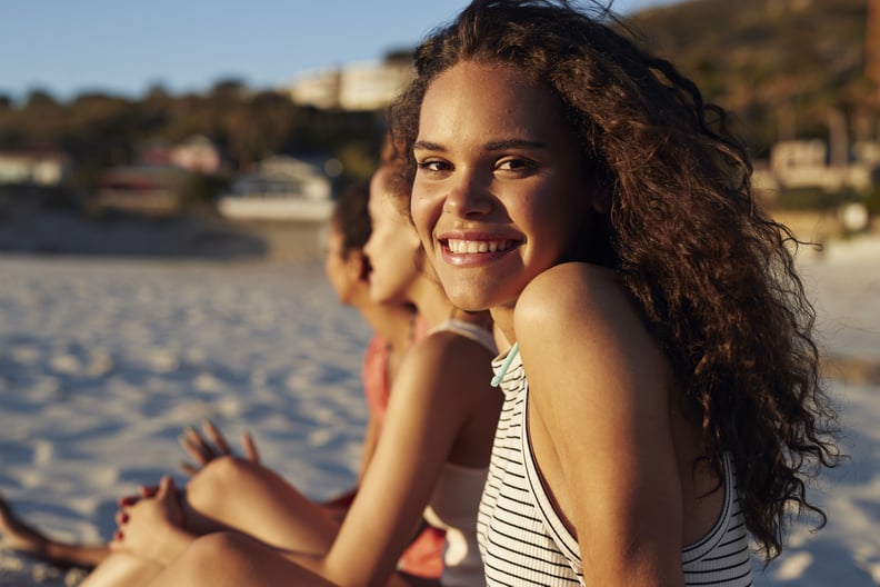 Young women hanging out at the beach, at sunset