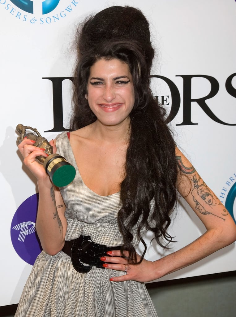 Amy smiled with her new trophy at the Ivor Novello Awards in May 2007.
