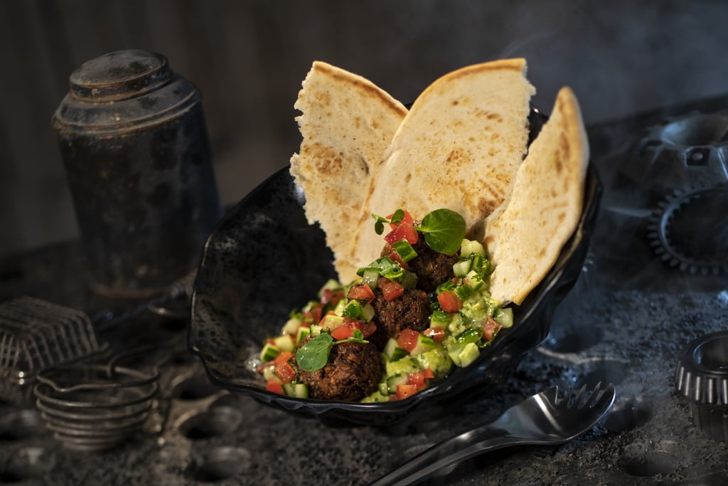 This Felucian Garden Spread, or a plant-based kefta "meatball" dish with herb hummus and tomato-cucumber relish with pita bread, can be found at Docking Bay 7 Food and Cargo.