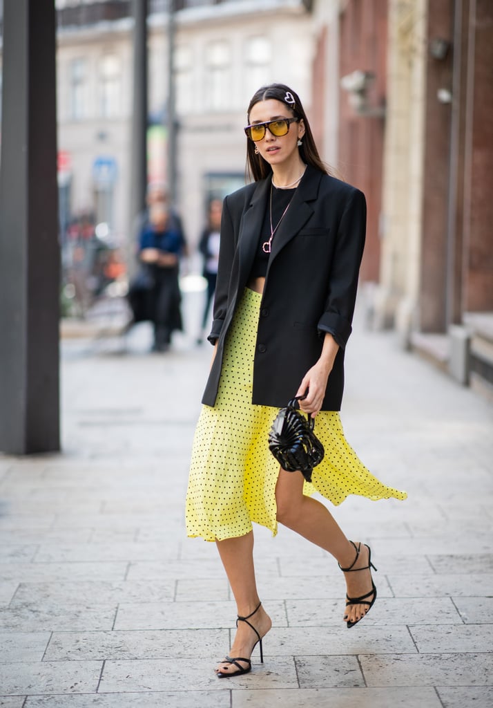 Make your yellow skirt stand out even more by styling it with a black tee and matching blazer.