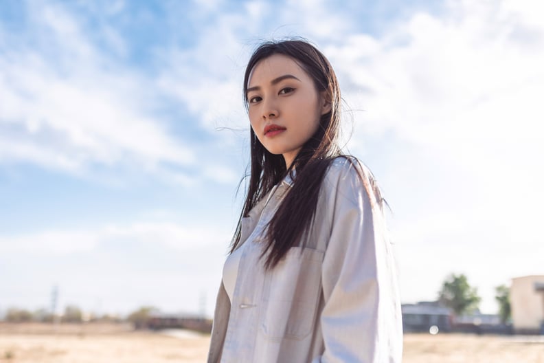 Portrait of Young Woman Looking Into Camera Outside
