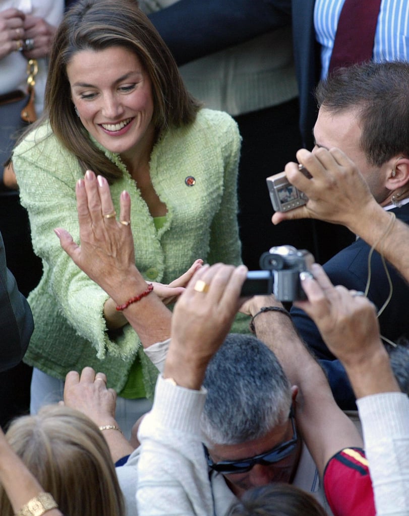 She greeted people at the Cathedral of Santiago during a visit with Prince Felipe.