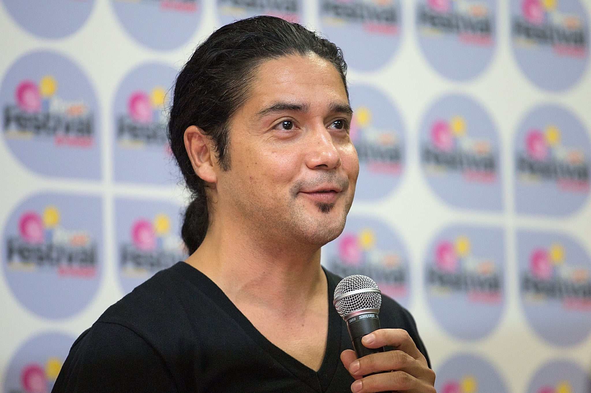 SAN ANTONIO, TX - SEPTEMBER 01:  Musician Chris Pérez of Chris Pérez Project speaks backstage during Festival People en Español Presented by Target at The Alamodome on September 1, 2013 in San Antonio, Texas.  (Photo by Rick Kern/Getty Images)