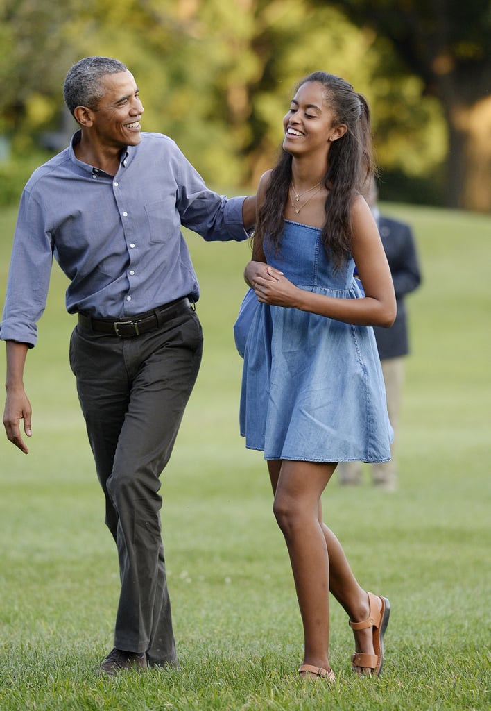Wearing a breezy denim spaghetti-strap dress.