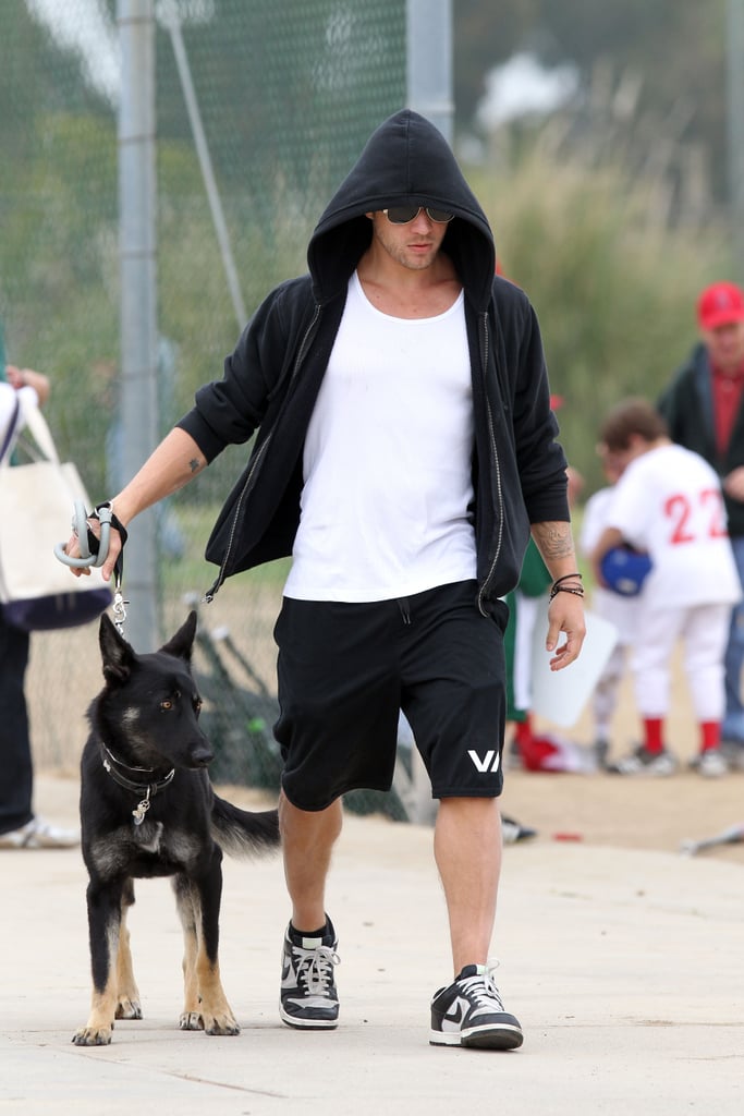 Ryan Phillippe adopted his German Shepherd from a shelter to cheer up his son, Deacon, and brought the pup along for one of Deacon's football games in LA in June 2011.