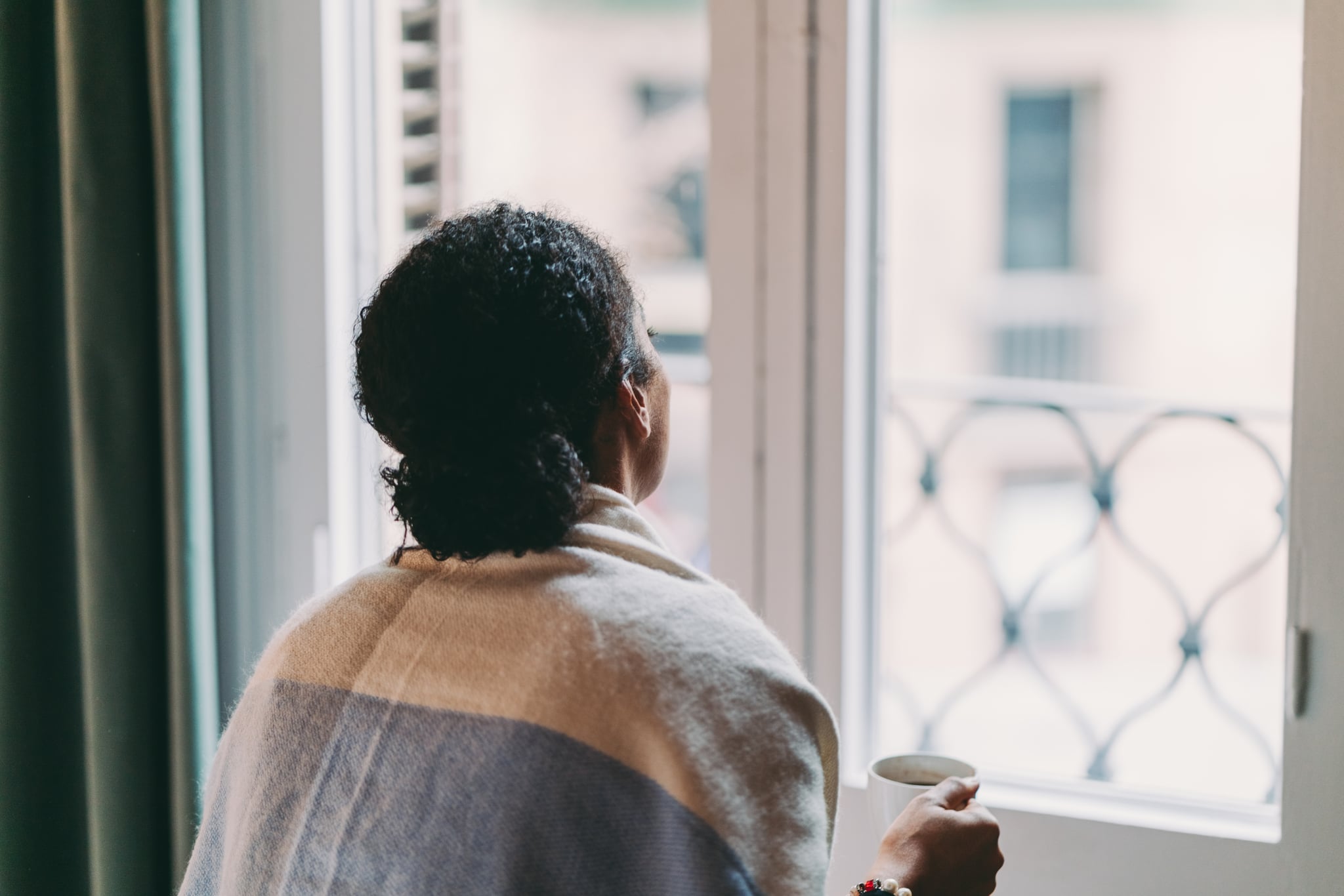 Woman in quarantine staying home, drinking coffee feeling depressed