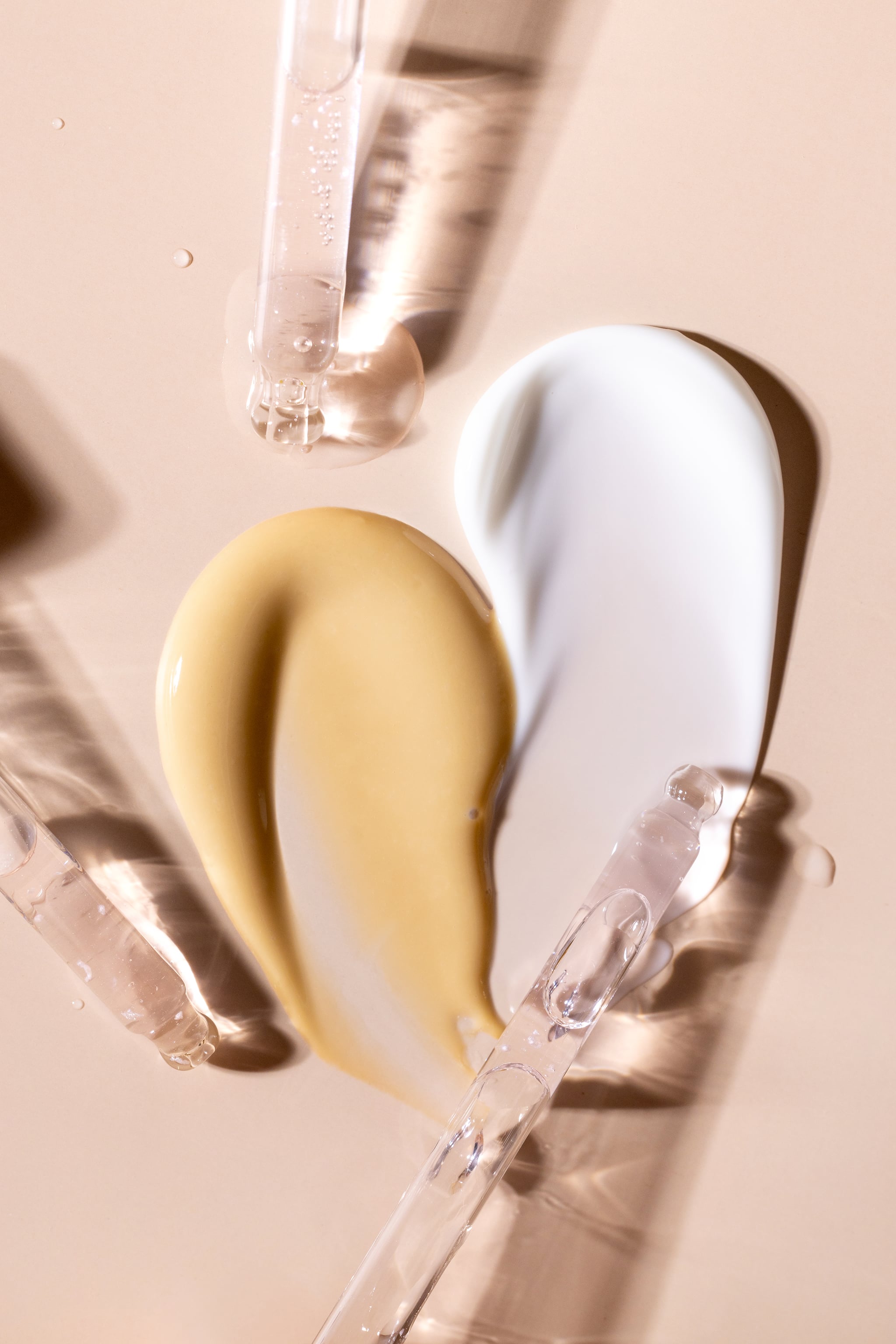samples of cosmetic products smears cream masks glass pipettes with serum cosmetics for face care on a beige background samples of cosmetic products smears cream masks glass pipettes with serum cosmetics for face care on a beige background