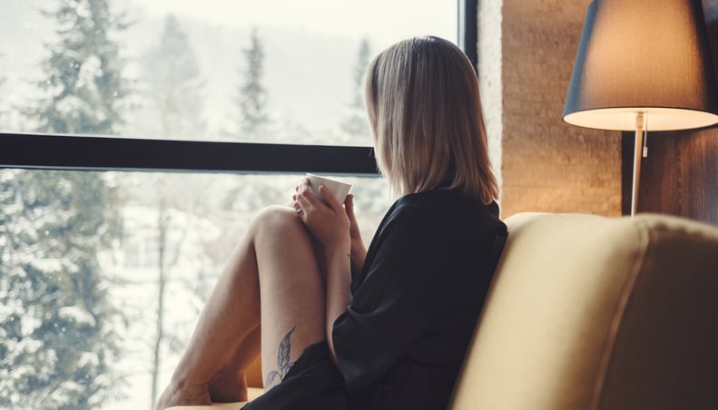 Young woman day dreaming with morning coffee.