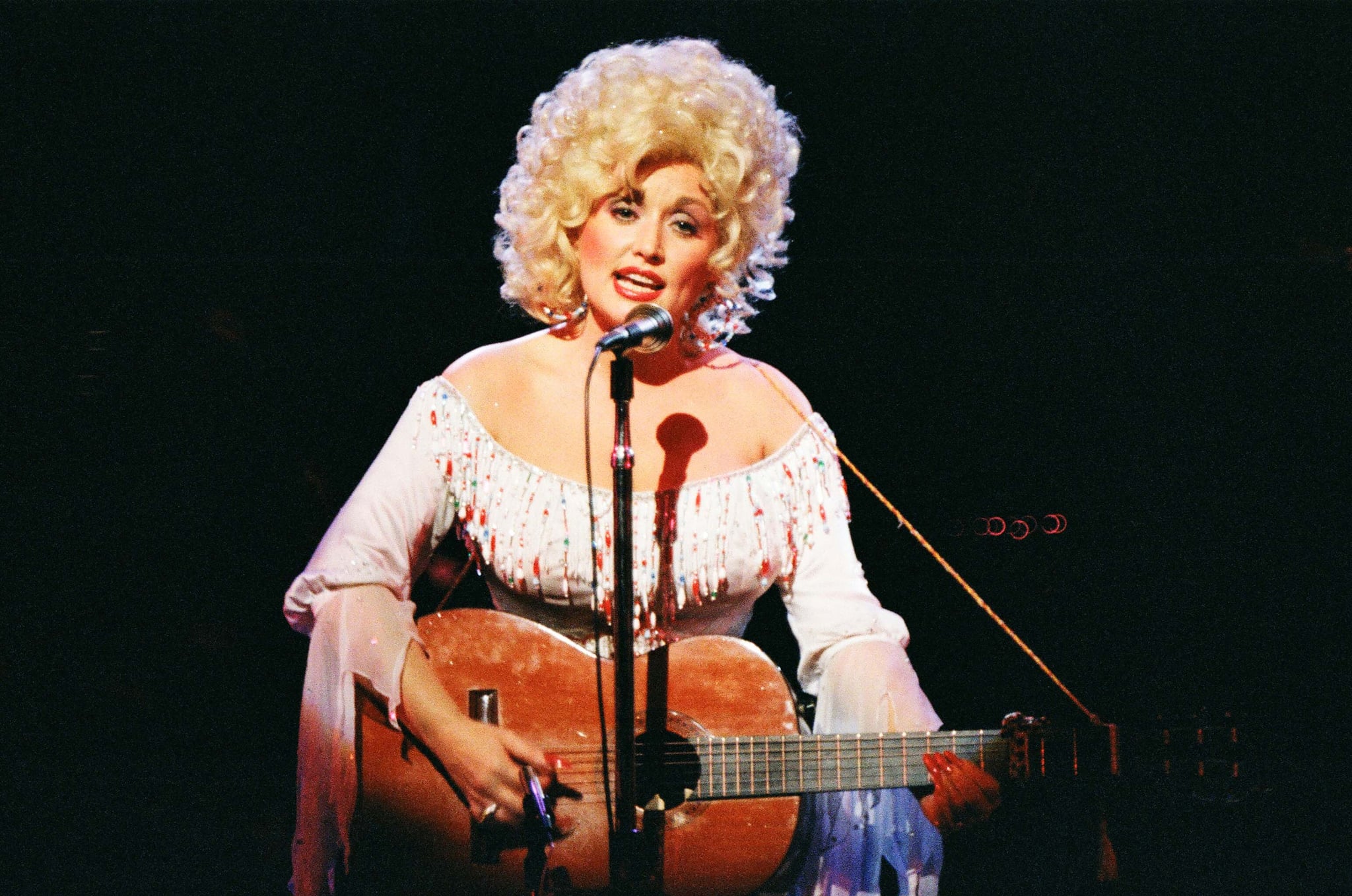 LONDON, UNITED KINGDOM - MARCH 4: Dolly Parton performs on stage at The Dominion Theatre on March 29th, 1983 in London, United Kingdom. (Photo by Pete Still/Redferns)