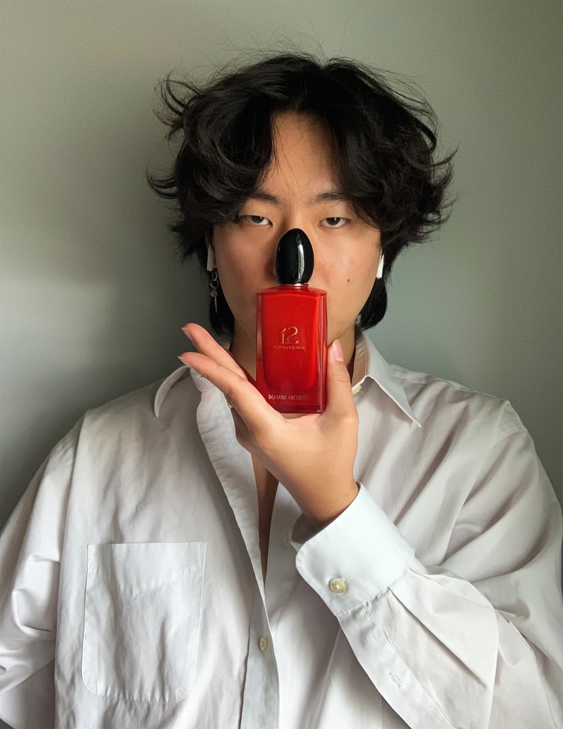 Josh Kim holding the fragrance Giorgio Armani Sì Passione