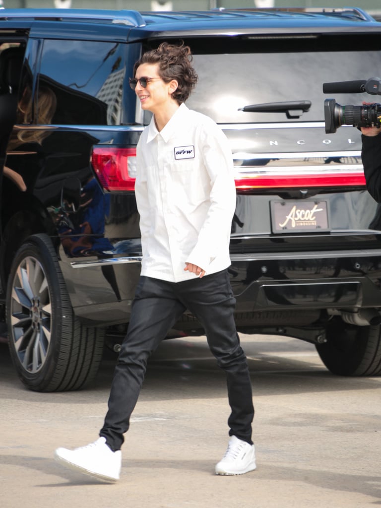 Hanging out in LA wearing an Off-White button-down, jeans, and white kicks.