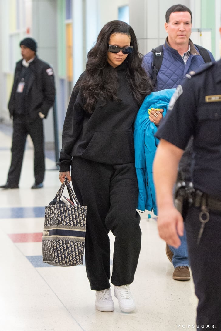 Rihanna Carrying Her Monogrammed Dior Tote Bag Through JFK Airport ...