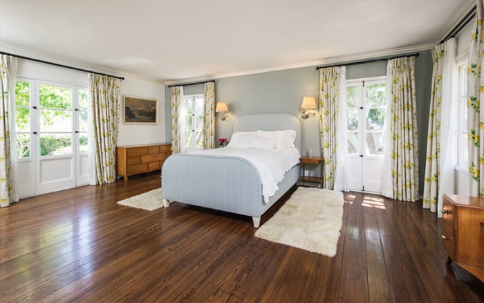 With hardwood floors and floral curtains, the bedroom has plenty of character without being cluttered.