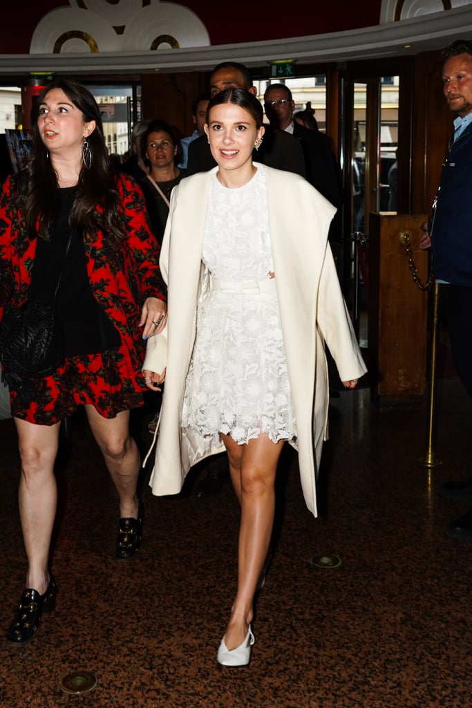 Millie Bobby Brown in a White Dress and Coat in 2019