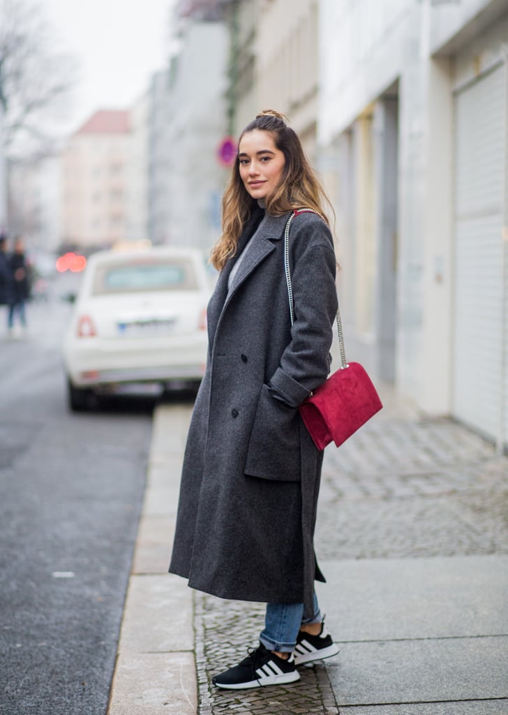 With Jeans, a Long Coat, and a Red Bag