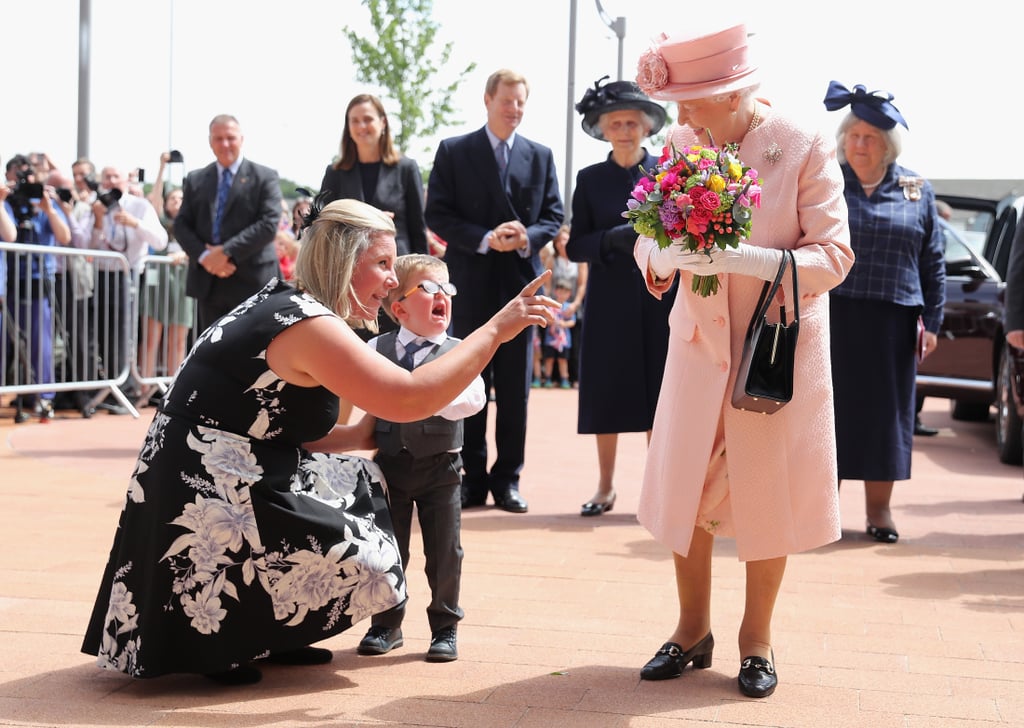 During a June visit to Liverpool, Queen Elizabeth received a bouquet of flowers from a very young admirer.