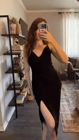woman wearing the spanx fancy plunge low back mid-thigh bodysuit underneath a dress
