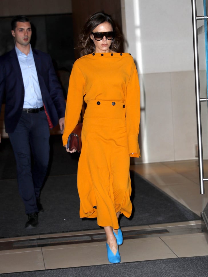 For a day in New York, Victoria wore a mustard dress, which she ...