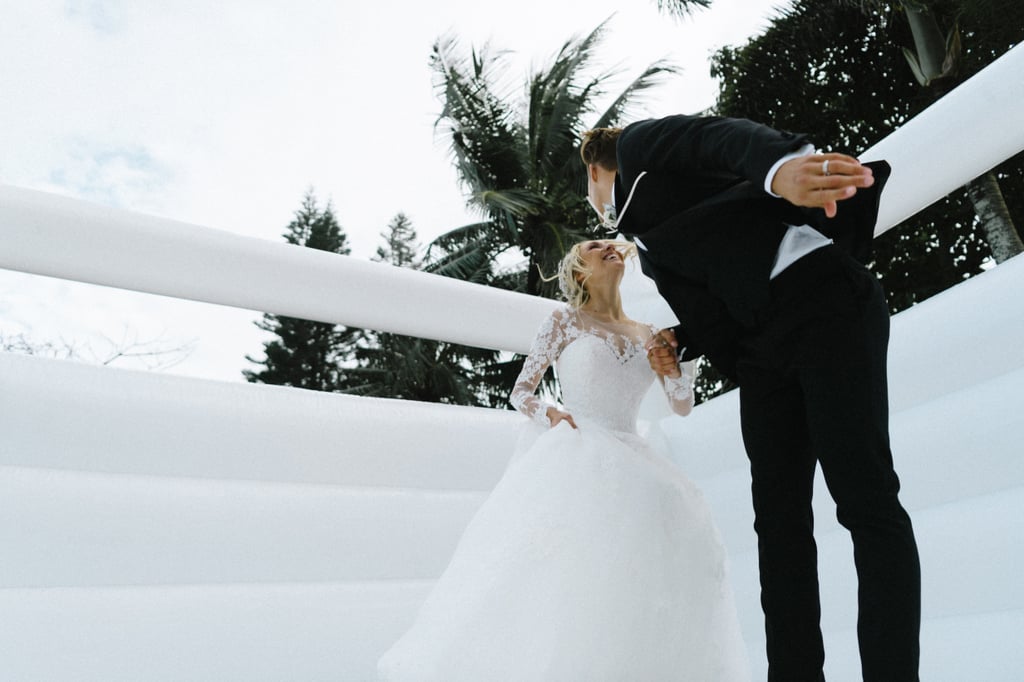 Couple Takes Wedding Photos in Bouncy Castle