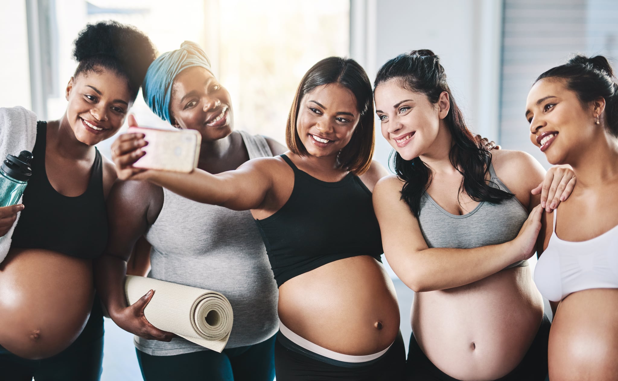 Shot of a beautiful group of young pregnant women taking a selfie together after a yoga session in studio