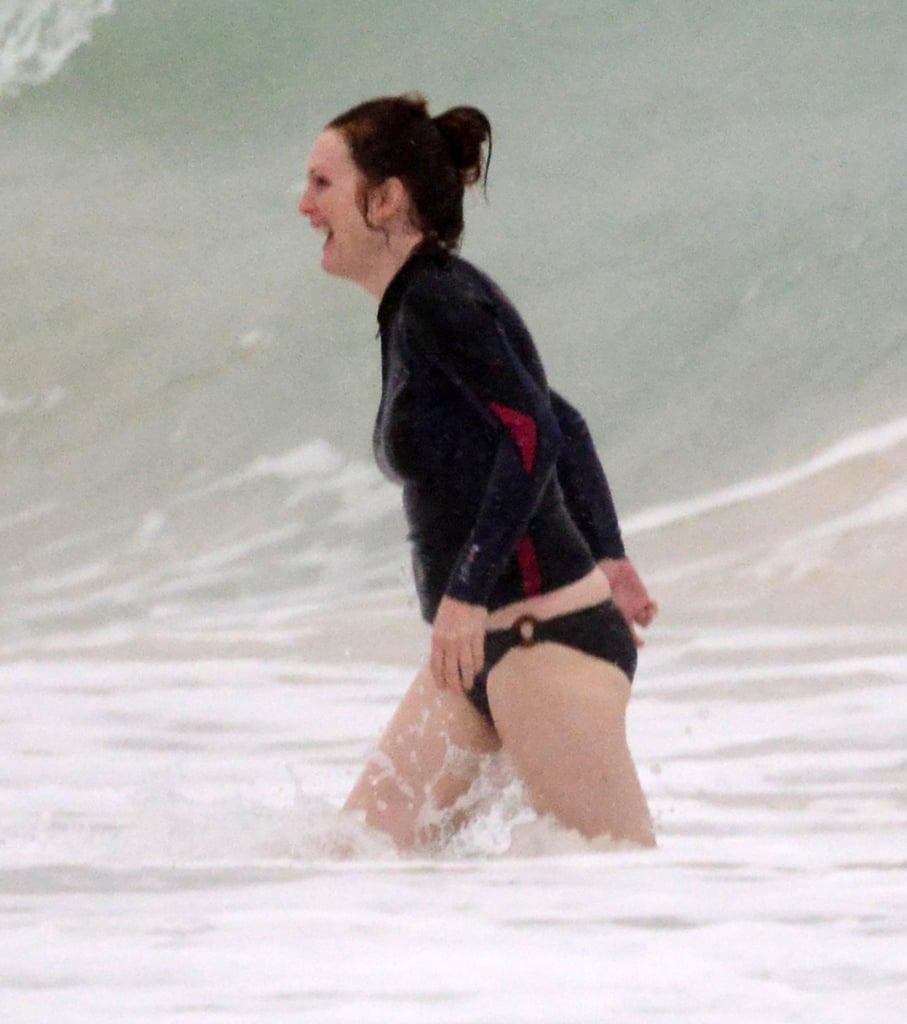 She wore a bikini bottom and a rash guard during her ocean dip.