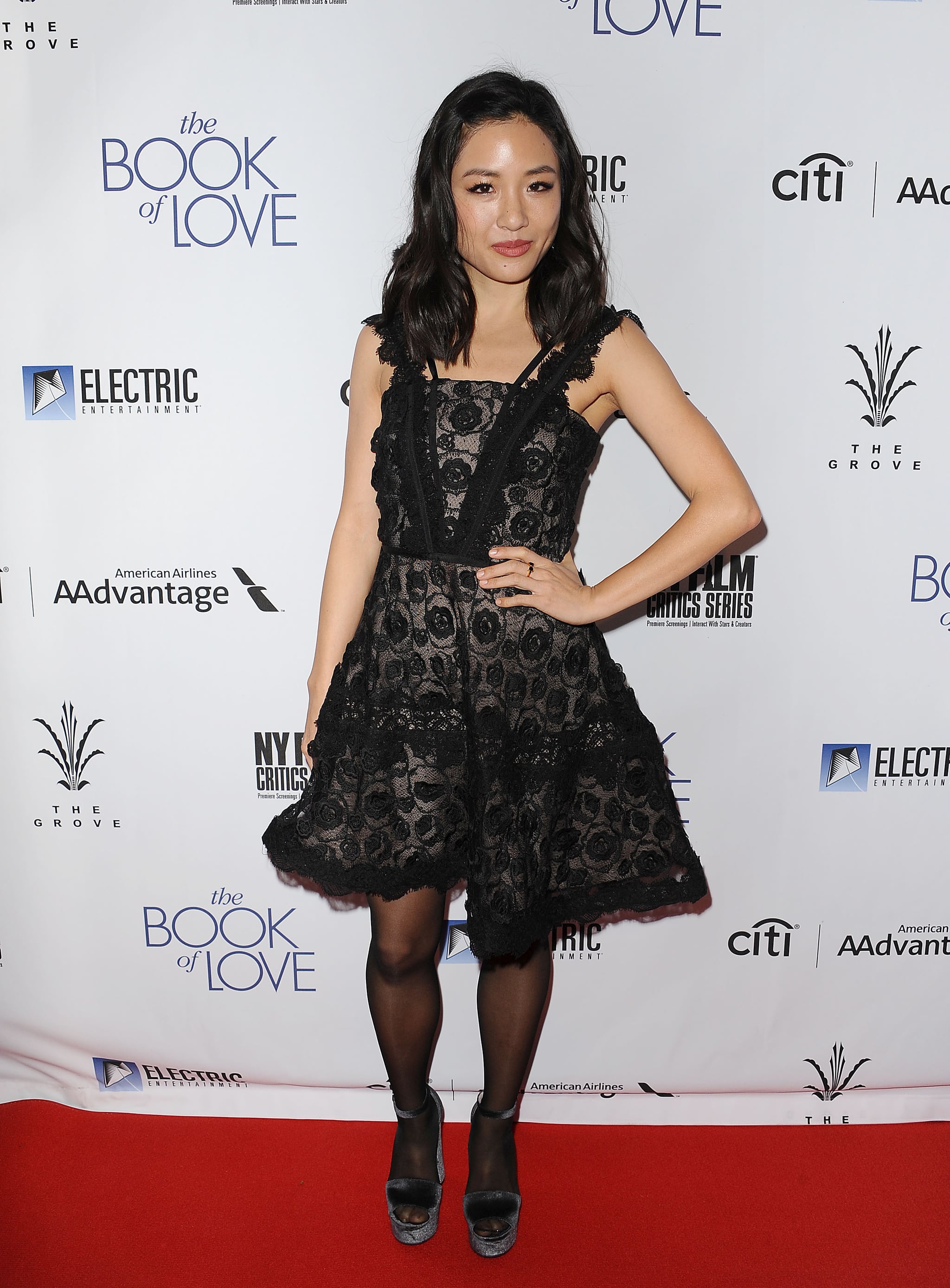 Wearing a sheer black minidress at the 